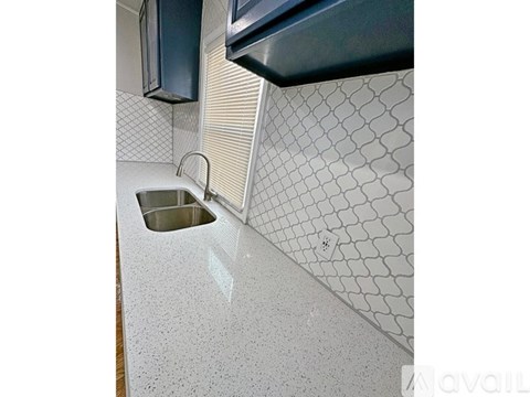 A kitchen counter with a sink and a microwave above it.