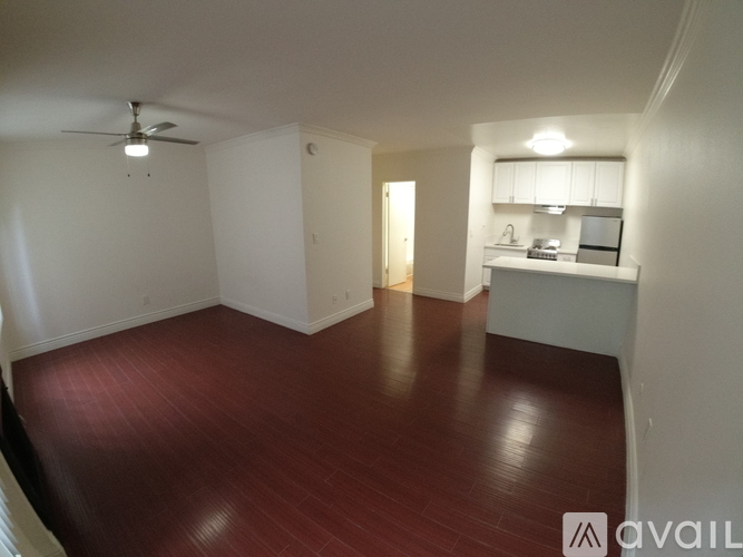 A room with a wooden floor and a ceiling fan.