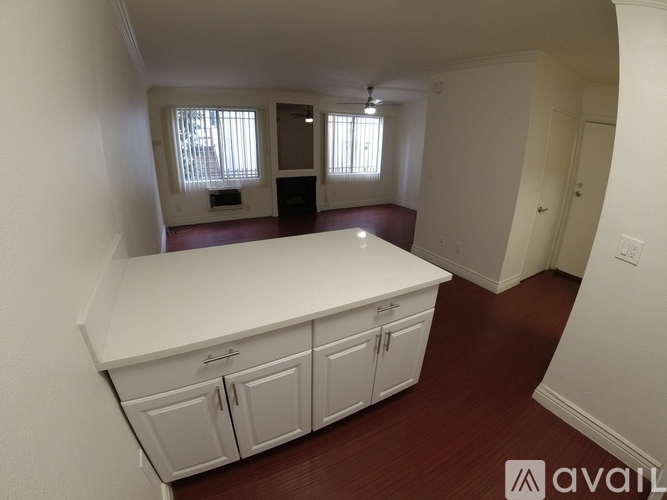 A kitchen with white cabinets and a countertop is available.