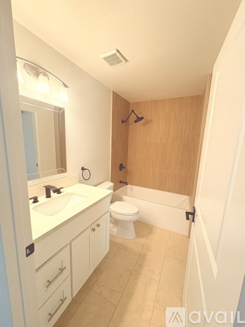 A bathroom with a sink, toilet, and bathtub.