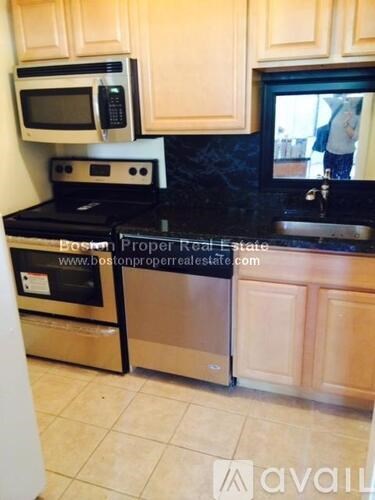 A kitchen with a stove top oven and a microwave above it.