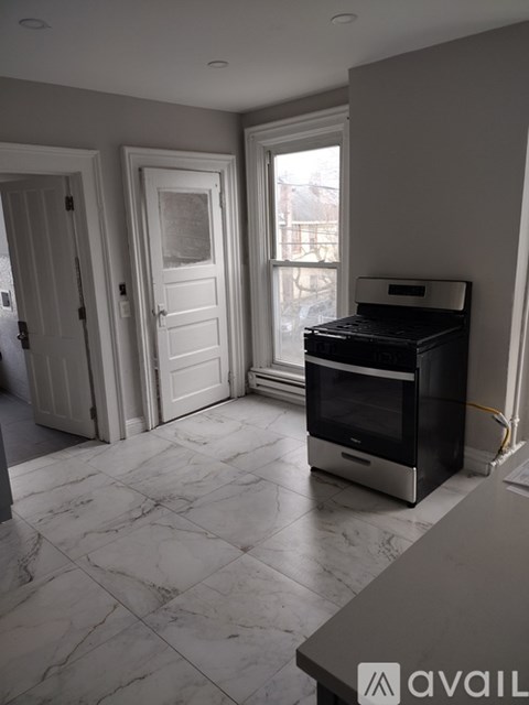 A room with a marble floor and a wood stove.