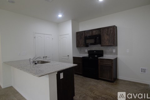 A kitchen with a sink and a microwave.