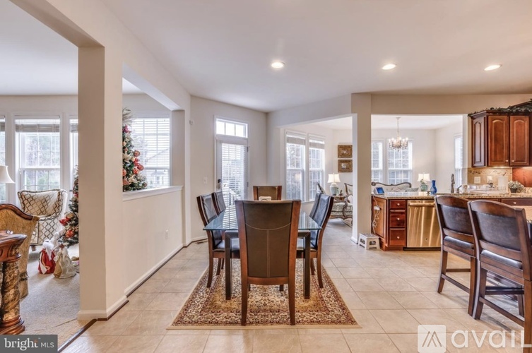 A dining room with a table set for six.