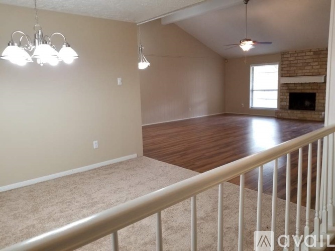 A living room with a fireplace and a balcony.