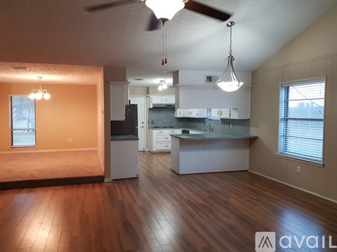 A kitchen with white cabinets and a darker countertop.