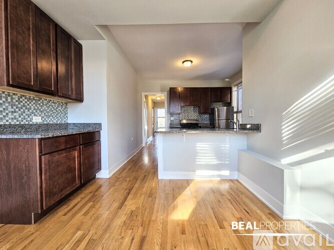 A kitchen with wooden cabinets and a checkered backsplash.