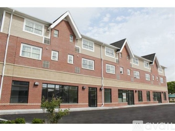 A multi-story building with a brick facade and large windows.