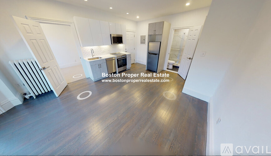 A spacious open floor plan with a kitchen, dining area, and a living room.