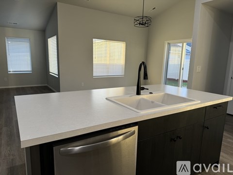 A modern kitchen with a white countertop and a stainless steel dishwasher.