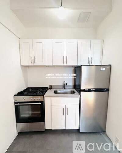 A kitchen with white cabinets and stainless steel appliances.