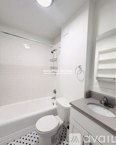 A white toilet sits next to a sink in a bathroom.