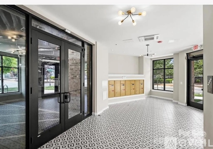 A spacious room with a tiled floor and a ceiling fan.