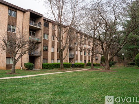 Apartment building with trees in front.