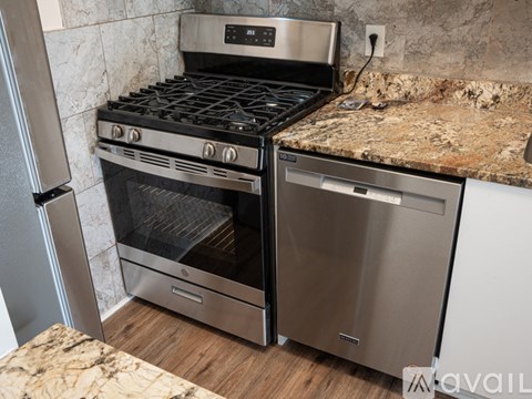 A modern kitchen with a stainless steel oven and dishwasher.
