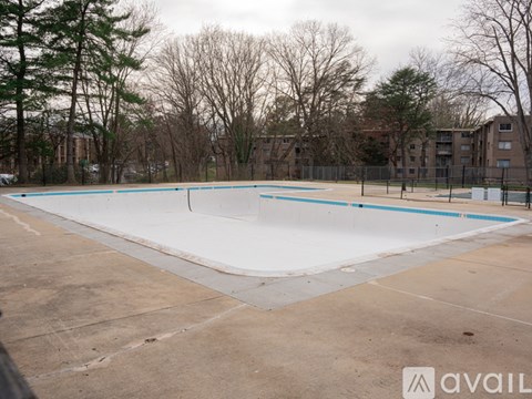 A skate park with a white ramp and blue pool.