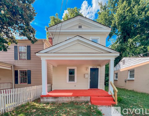 A house with a red staircase leading to the front door.
