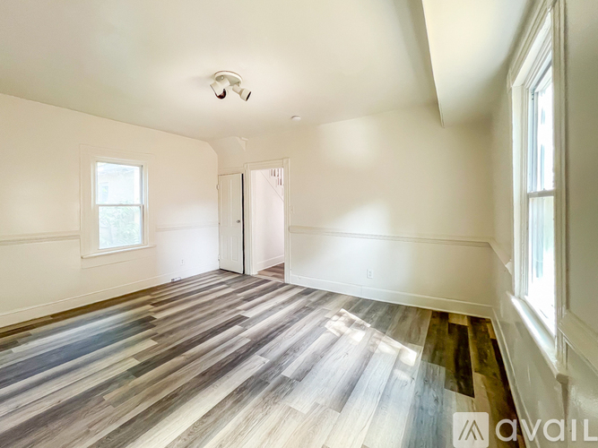 A room with a wooden floor and a ceiling fan.