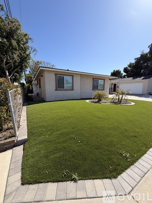 A house with a well-kept lawn in front.