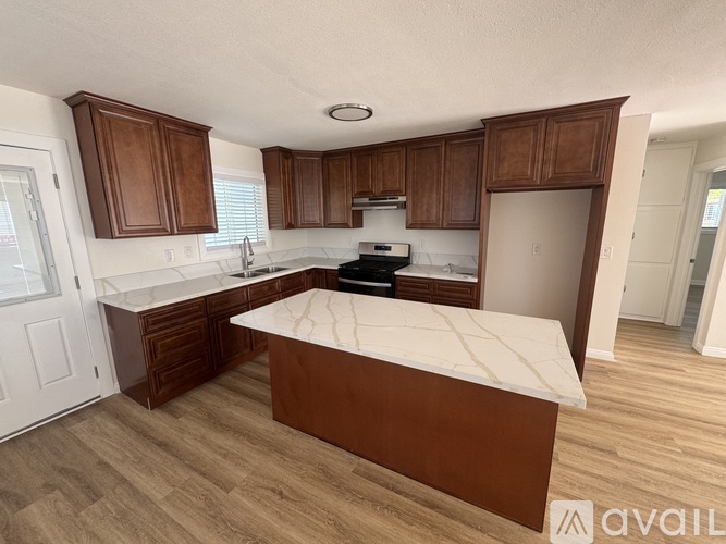 A kitchen with wooden cabinets and a white countertop.