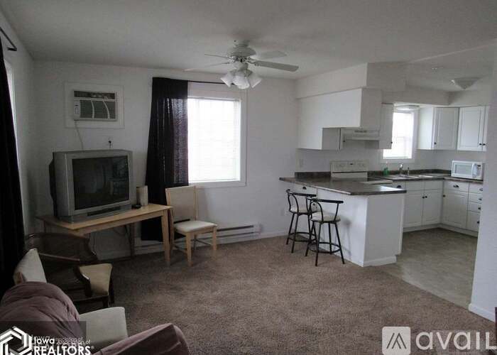 A living room with a television set on a wooden table.