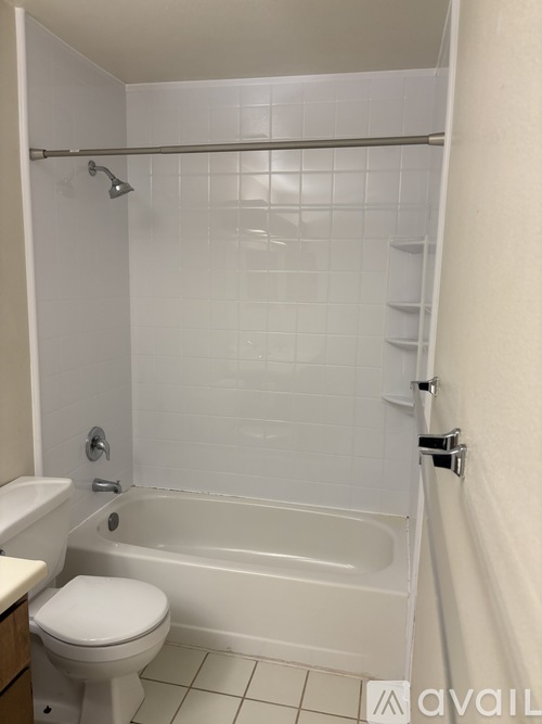 A white toilet is next to a white bathtub in a bathroom.