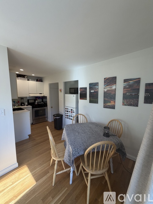 A dining room with a table set for four.