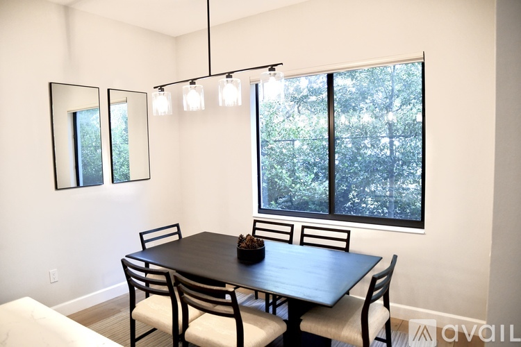 A dining room with a table and chairs.