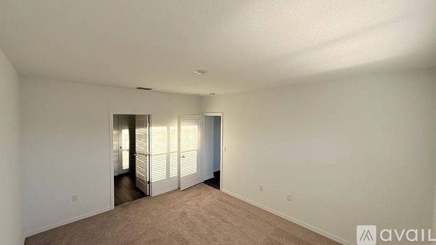 A room with a carpeted floor and a door with a window.