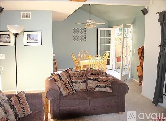 A living room with a couch and a chair.
