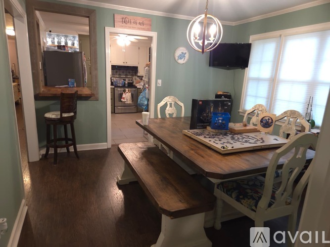 A dining room with a wooden table and chairs.