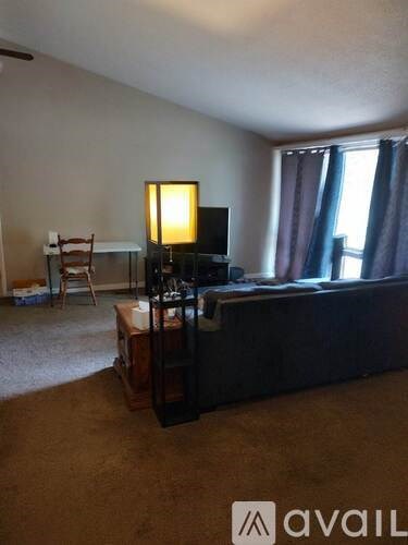 A living room with a television and a chair.