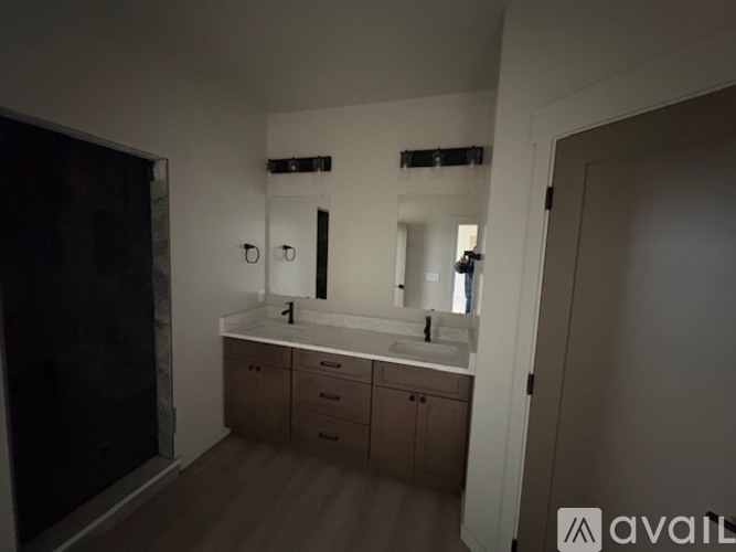 A bathroom with a sink, mirror, and cabinets.