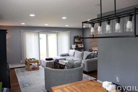 A modern living room with a grey sofa and a wooden coffee table.