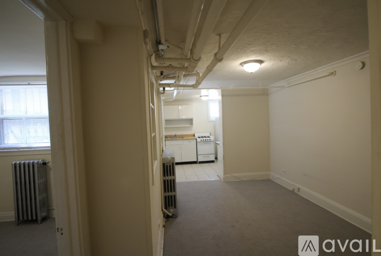 A room with a window, a radiator, and a washing machine.