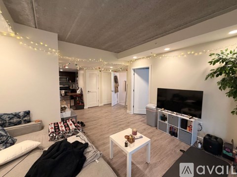 A living room with a couch, coffee table, and a television.