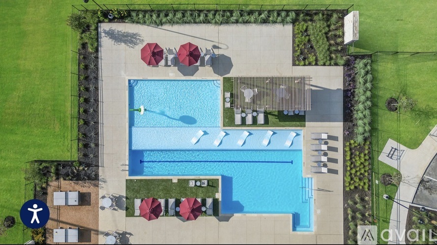 A swimming pool with a slide and sun loungers.