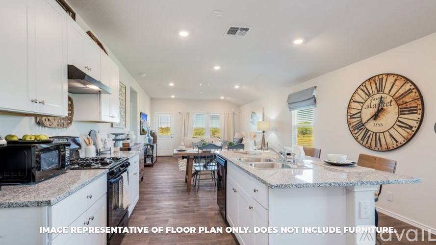 A kitchen with white cabinets and a black stove top.