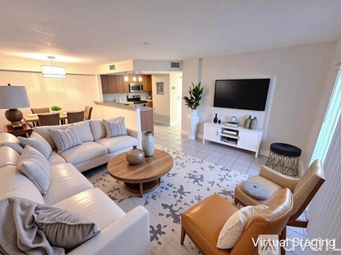 A living room with a white couch and a coffee table.