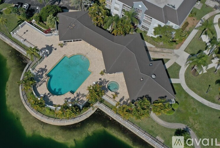 An aerial view of a house with a pool and a large backyard.