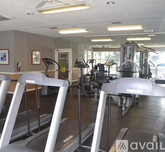 A gym with treadmills and other exercise equipment.