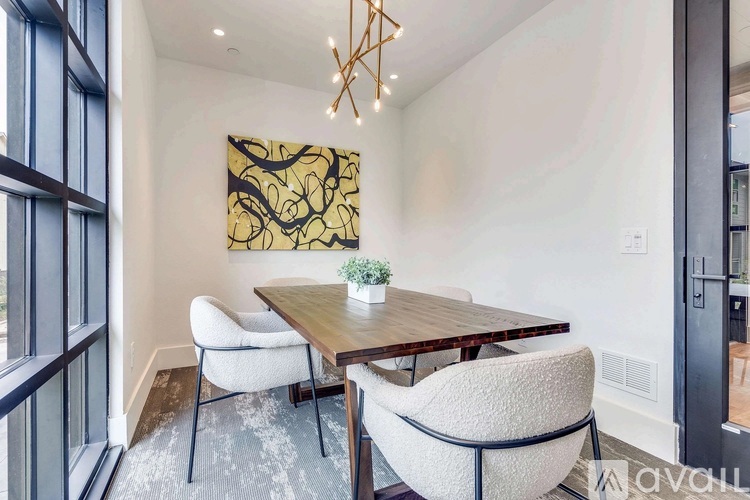 A dining room with a wooden table and chairs.