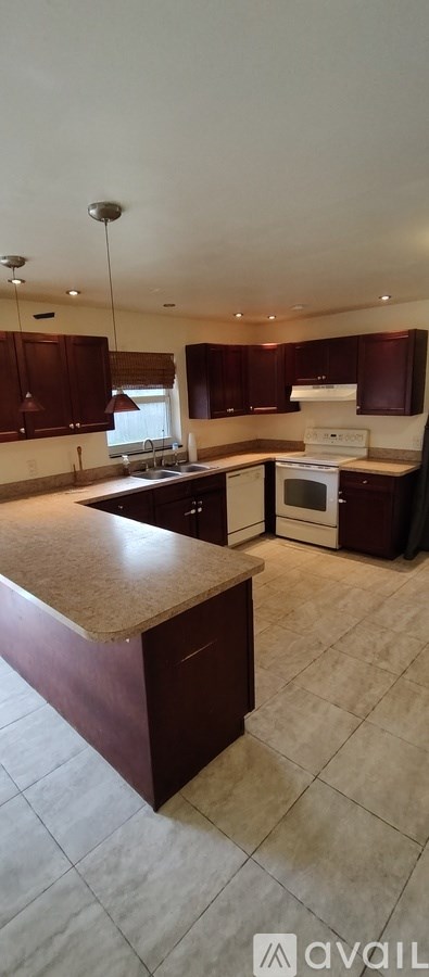 A kitchen with brown cabinets and a white oven.