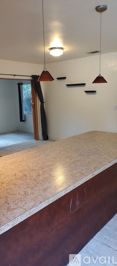 A room with a marble counter top and a light fixture.