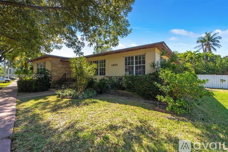 A house with a lawn in front of it.