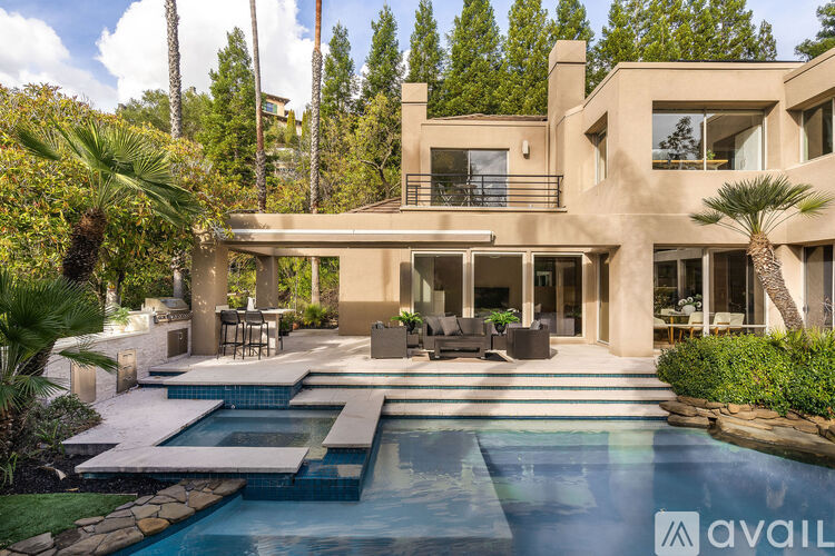 A modern house with a pool in the backyard.