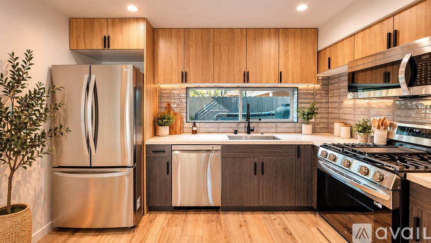 A modern kitchen with wooden cabinets and stainless steel appliances.