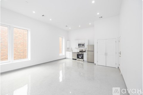 A spacious kitchen with white cabinets and a large island.