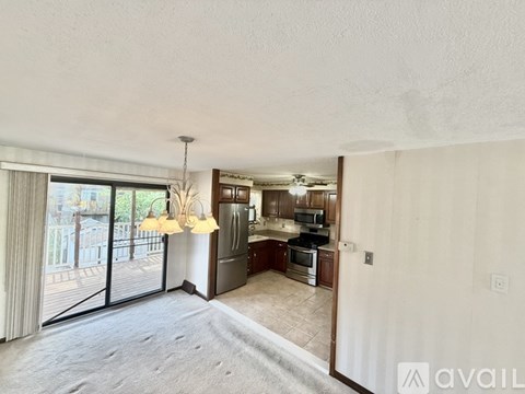 A well-lit kitchen with a refrigerator, oven, and microwave.