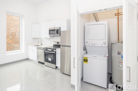 A kitchen with white appliances and cabinets.
